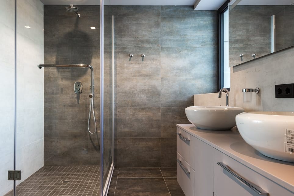 curtis design build bathroom renovations Stylish bathroom interior featuring ceramic sinks, glass shower, and elegant finishes.