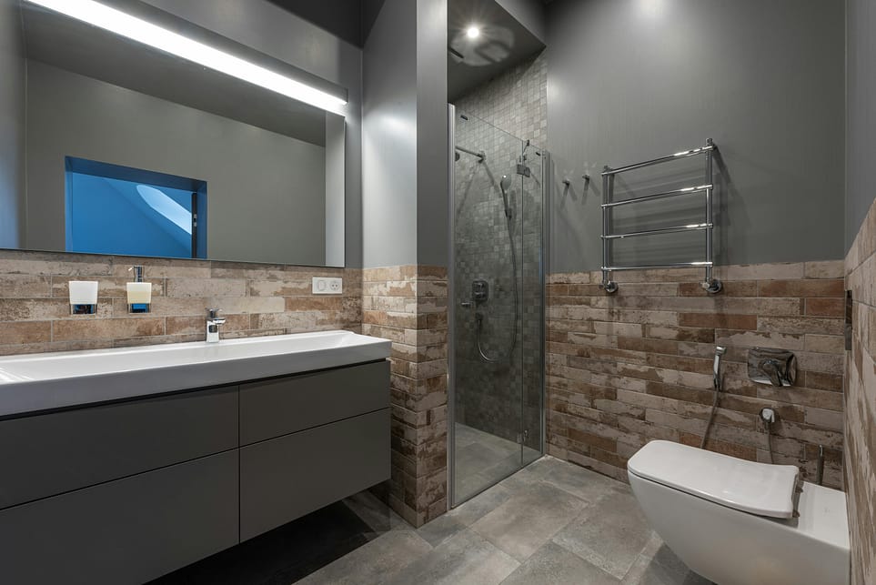 pexels-photo-8143696-8143696 Sleek modern bathroom featuring a glass shower, floating vanity, and stylish decor.