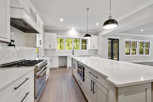 pexels-photo-10099327 Bright modern kitchen with white cabinets and large island countertop.