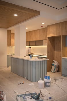 pexels-photo-15124969 Contemporary kitchen undergoing renovation with wooden cabinets and clean design.